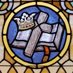 Bible, cross, and crown stained glass window